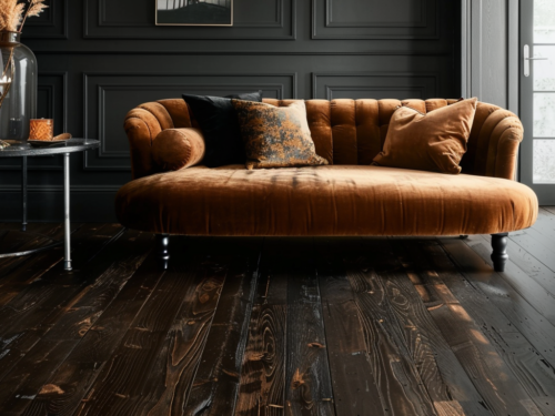 Dark wood flooring and a velvet sofa