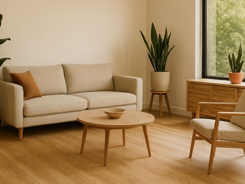 Photograph of a clean, minimalist living room with eco-friendly bamboo flooring, potted plants, and neutral-toned furniture near a large window.